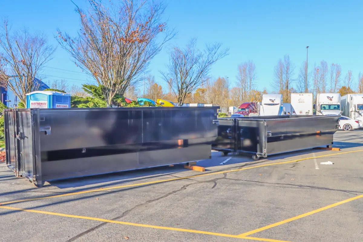 Professional dumpster rental service with roll-off container on residential driveway in Apopka